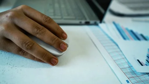 Hand Using Mouse with Laptop and Documents, Close-up of a hand using a comp.. Stock Footage 304977903