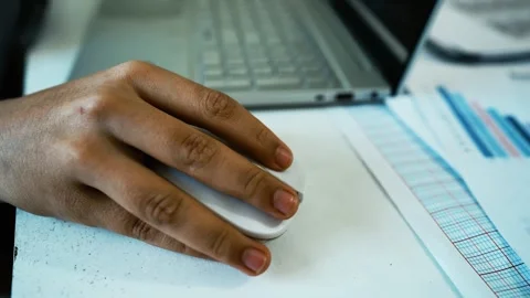 Hand Using Mouse with Laptop and Documents, Close-up of a hand using a comp.. 動画素材 304977960