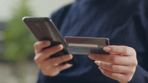 Hand using phone and credit card for shopping online or credit payment Stock Footage 190695138