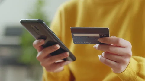Hand using phone and credit card for shopping online or credit payment Stock Footage 190695371