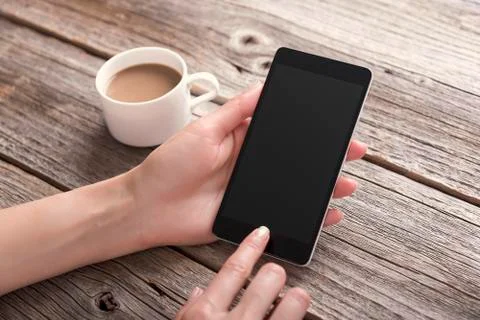 Hand using phone with blank screen. Stock Photos