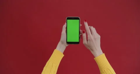 Hand using phone with green screen, chroma key. Touch and swiping on red Stock Footage 150828667