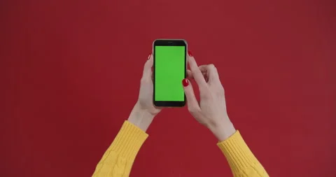 Hand using phone with green screen, chroma key. Touch and swiping on red Video stock 150828705