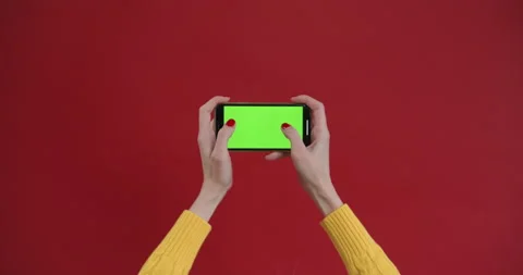Hand using phone with green screen, chroma key. Touch and swiping on red Stock Footage 150828901