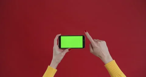 Hand using phone with green screen, chroma key. Touch and swiping on red Stock Footage 150829053