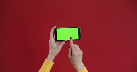 Hand using phone with green screen, chroma key. Touch and swiping on red Stock Footage 150829099