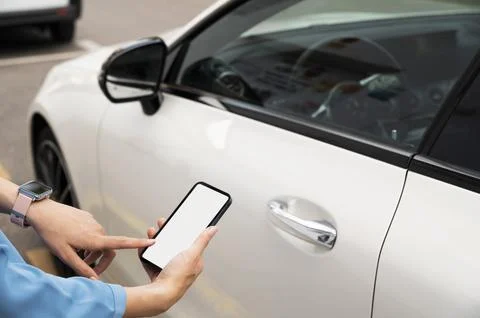 Hand using phone to lock car Photo Stock Photos