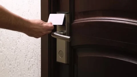 Hand using plastic electronic contactless card key to open door of hotel room Video stock 310712340