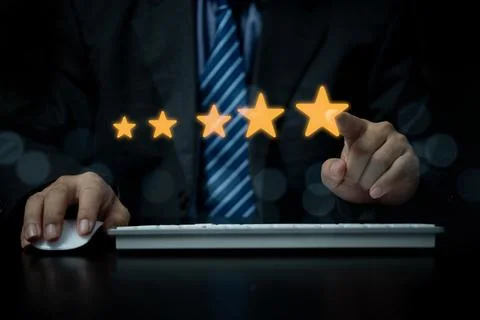 Hand using with popup five star icon for feedback review satisfaction servi.. Stock Photos