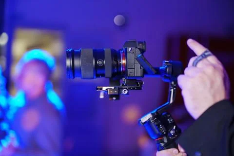 Hand using professional camera gimbal stabilizer Stock Photos