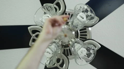 Hand using the pull cord to turn a Ceiling fan light on Stock Footage 63213553