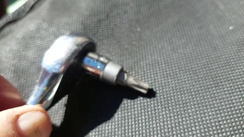 Hand using ratchet wrench with Torx bit close up Stock Footage 334678442