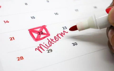 Hand Using a Red Marker to Circle an Important Midterm Exam Date on a Calen.. Stock Photos