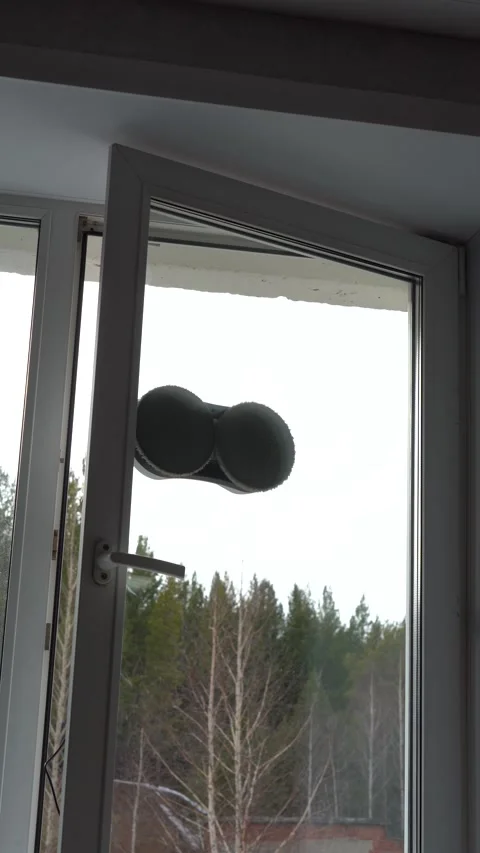 A Hand Using a Remote Control to Operate a Window with Balloons Attached, 스톡 동영상 333514363
