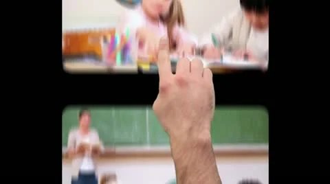 Hand using screens with children at school Stock Footage
