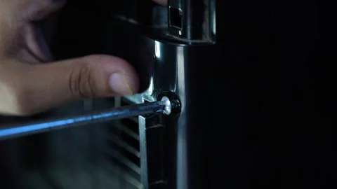 Hand using screwdriver to repair household appliance, Close-up of a hand us.. Video stock 338319441