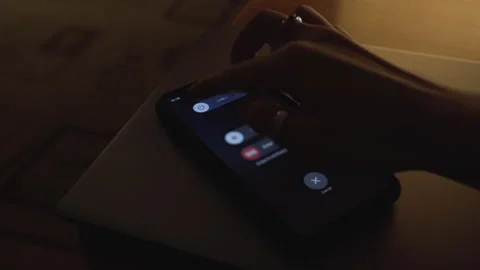 Hand using is sliding to turn off the mobile phone to reduce power consumption Stock-Footage 255634899