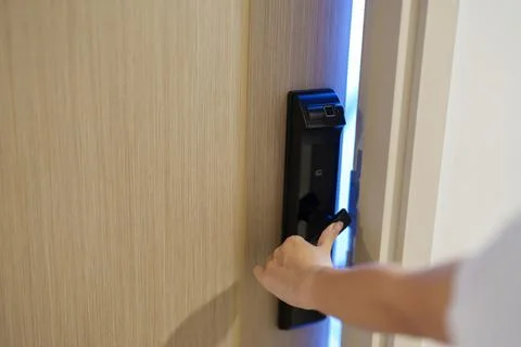 Hand using smart digital door lock while open or close the door at home or .. Stock Photos