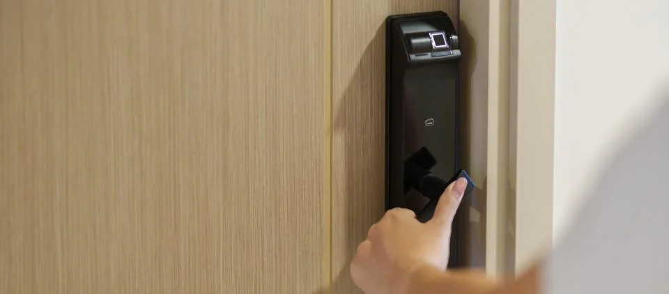 Hand using smart digital door lock while open or close the door at home or .. 写真素材