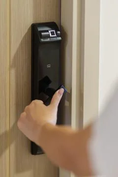 Hand using smart digital door lock while open or close the door at home or .. Stock Photos