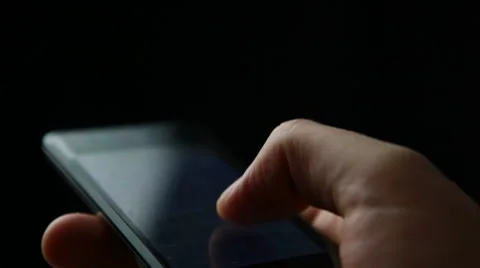 Hand using smart phone with dark dramatic lighting Video stock 58237683
