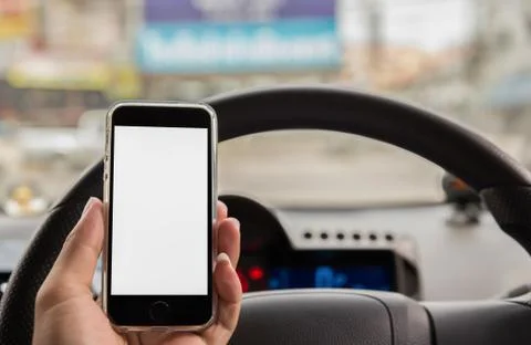 Hand using smart phone at steering wheel car Stock Photos