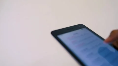 Hand Using Smartphone Against Plain Background Stock Footage 320724078