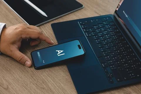 Hand using smartphone with AI interface beside laptop and tablet on office .. 스톡 사진