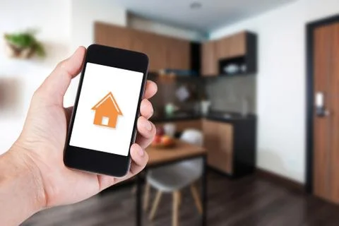 Hand using smartphone by app smart home on mobile for remote control everythi Stock Photos