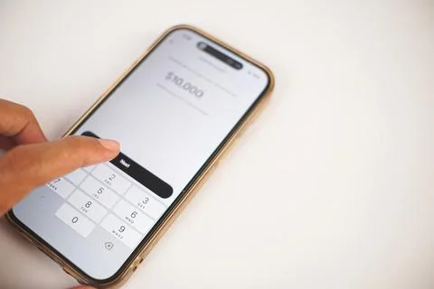 Hand using smartphone banking app for money transfer Фото