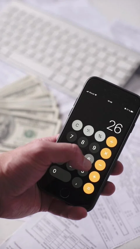 Hand Using Smartphone Calculator App Near Cash and Keyboard Stock-Footage 348736588
