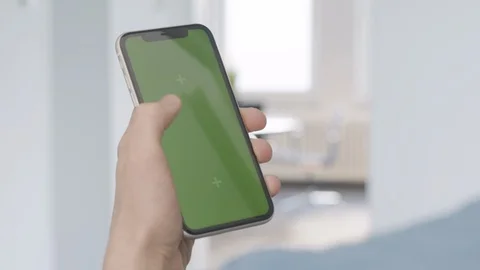 Hand using smartphone with greenscreen in office Stock Footage 125693317