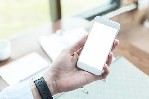 Hand using smartphone in office. Checking e-mail. Business smart connection t Stock Photos