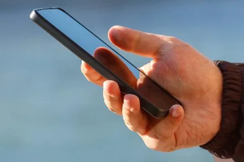 Hand using smartphone outside 스톡 사진
