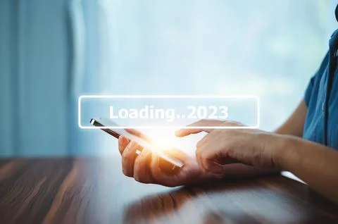 Hand using smartphone search on bar for loading 2023, start new year 2023 c.. Stock Photos
