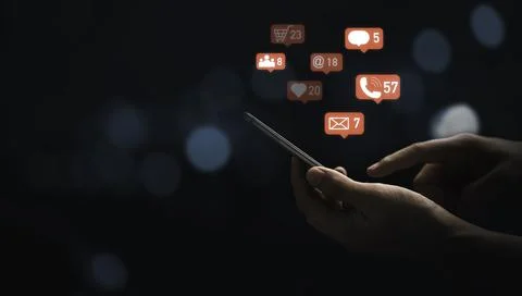 Hand using smartphone to send message and social media icons with blue bokeh Stock Photos