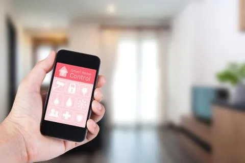 Hand using smartphone to smart home app on mobile for remote control everythi Stock Photos
