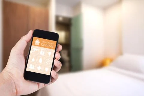 Hand using smartphone to smart home app on mobile for remote control everythi Stock Photos