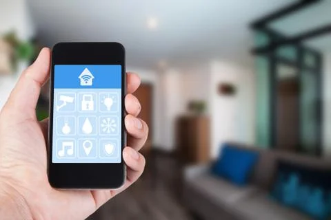 Hand using smartphone to smart home app on mobile for remote control everythi Stock Photos