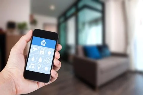 Hand using smartphone to smart home app on mobile for remote control everythi Stock-Fotos