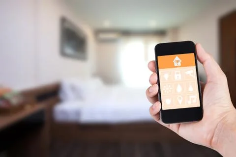Hand using smartphone to smart home app on mobile for remote control everythi Stock-Fotos