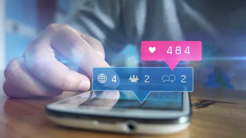 Hand using smartphone with social media icons Stock Footage 129665712