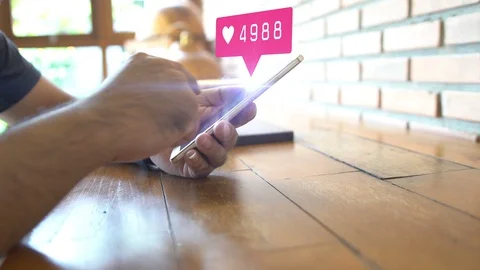 Hand using smartphone with social media icons Stock Footage 129666131