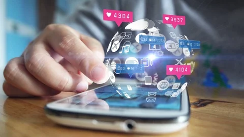 Hand using smartphone with social media icons Stock Footage 129666401
