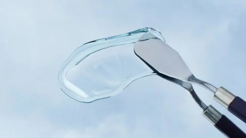 Hand using spatula applies smear of shampoo or shower gel against the background Stock Footage 280164168