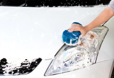 Hand using sponge washing car Stock Photos