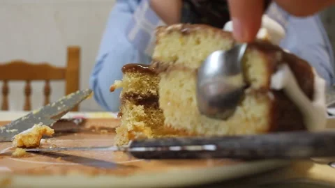 Hand using spoon and knife to serve a slice of homemade cake Stock Footage 342455719