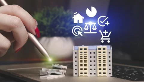 Hand using a stylus interacts with a virtual apartment building model on a .. Fotos de archivo