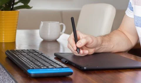 Hand using stylus pen and graphic tablet Stock Photos