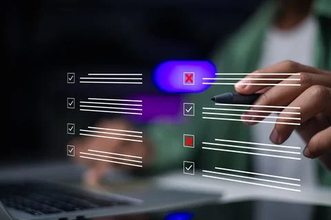 Hand using stylus pen to evaluate checklist on laptop. Businessman checking.. Stock Photos